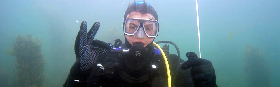 Learning to Scuba Dive. Holding on to a line and giving the OK signal